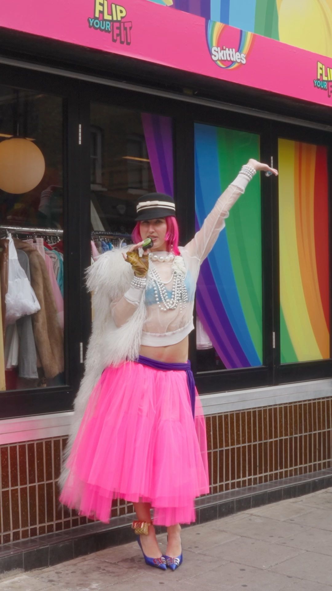 Abigale Masters in a pink tulle skirt and white faux fur outside the Flip Your Fit salon on Hoxton Street